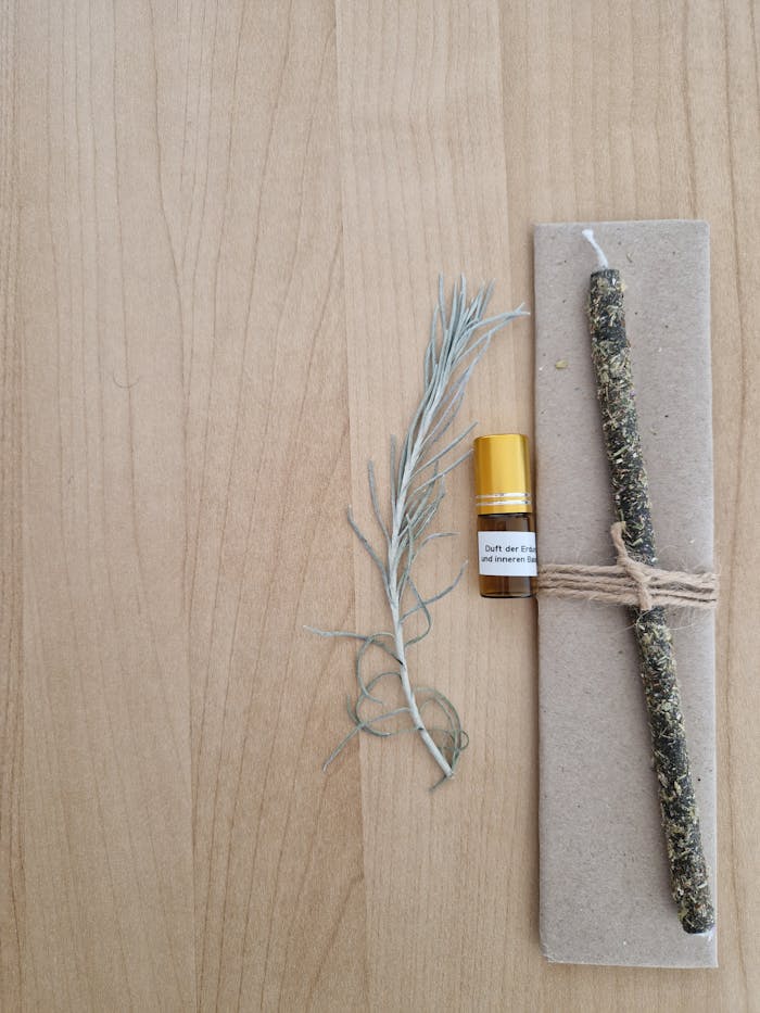 Natural herbal incense stick and essential oil on wooden surface for aromatherapy and relaxation.
