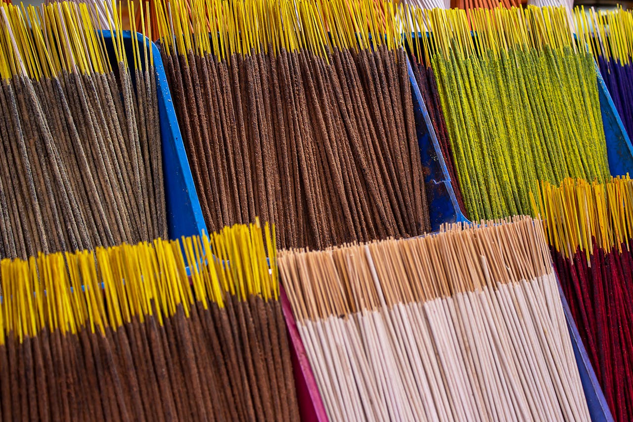 Vibrant incense sticks in various colors neatly arranged for sale, creating a striking visual.